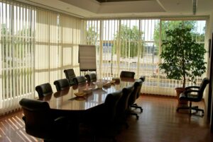 White vertical blinds in a wooden styled meeting room