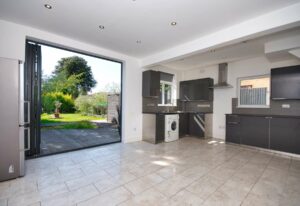 Bifold doors in a kitchen area overlooking the garden.