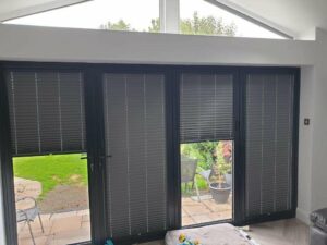 A set of perfect fit blinds that are half and fully closed.