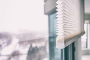 A set of cellular honeycomb blinds displayed on a set of windows.