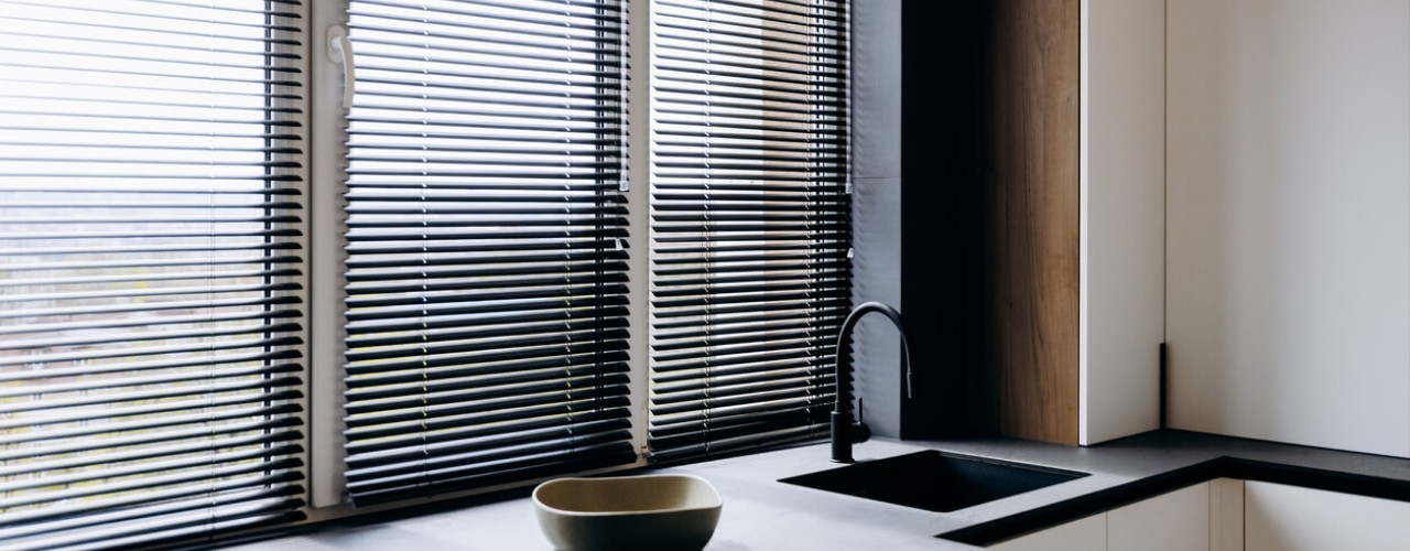 Faux wood Venetian blinds are a great solution for sunlit spaces because their composite material reflects harmful UV rays without warping