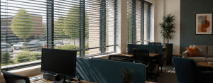 Office blinds controlling natural light and reducing screen glare across workstations in a modern hybrid workspace.
