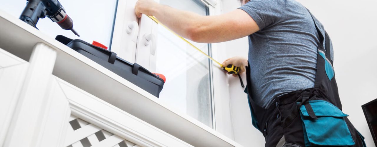 Image of handy man installing blinds because proper installation is cheaper than doing it incorrectly or poorly the first time. Blinds shops in Liverpool like Excell Blinds do it properly
