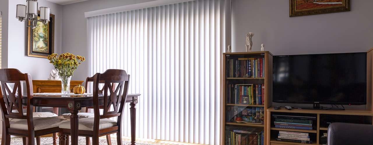 A set of blinds attached to sliding doors.