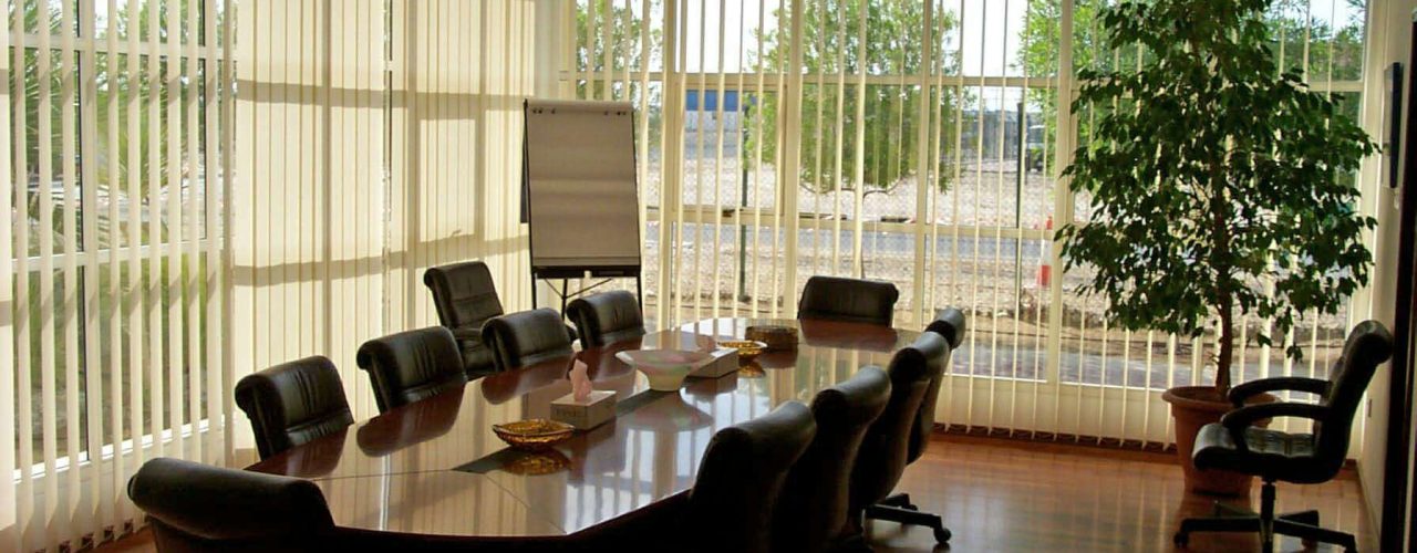 White vertical blinds in a wooden styled meeting room