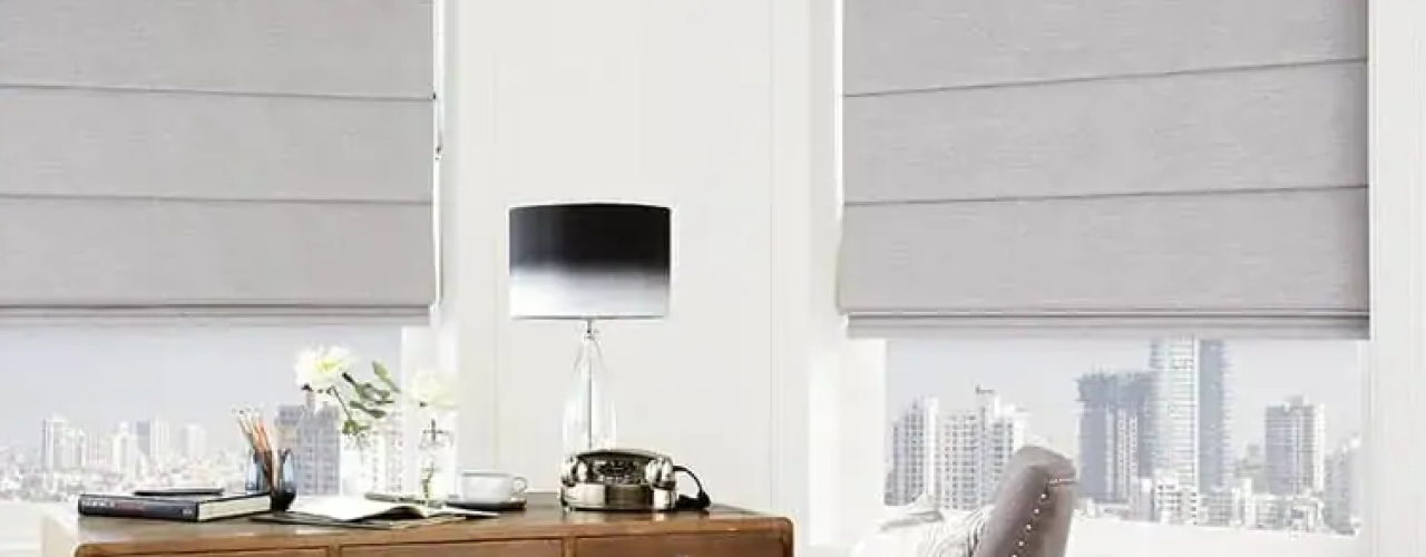 Grey roman blinds in a white home office